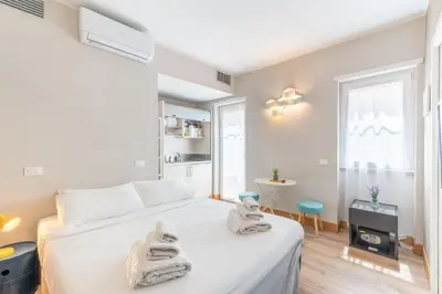 a bedroom with a white bed with towels on it at Double Pixel Apartments - Wonderful Stay in Rome
