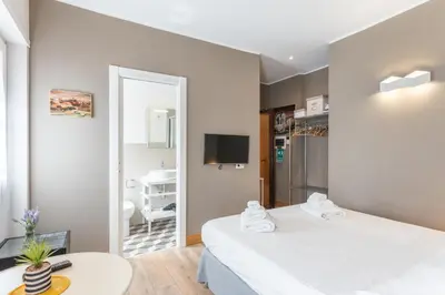 a bedroom with two beds and a mirror at Double Pixel Apartments - Wonderful Stay in Rome