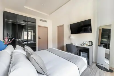 a bedroom with a large white bed and a desk at Domus 28 in Rome