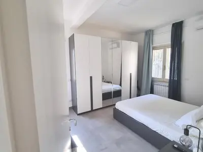a bedroom with a bed and a large mirror at Pigneto Giardino e Posto Auto Privati in Rome