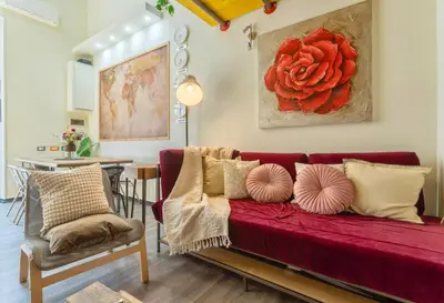 a living room with a red couch and a table at Rossana Urban Style Loft close to Termini Station in Rome