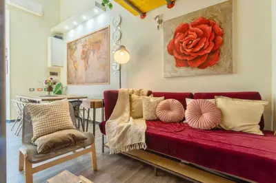 a living room with a red couch and a table at Rossana Urban Style Loft close to Termini Station in Rome