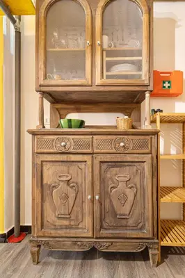 a wooden cabinet with glass doors in a room at Rossana Urban Style Loft close to Termini Station in Rome