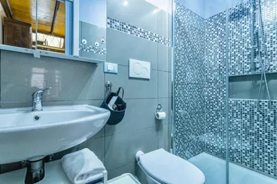 a bathroom with a sink and a toilet and a shower at Rossana Urban Style Loft close to Termini Station in Rome
