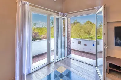 an empty living room with sliding glass doors at Villa Ada Apartment - Parioli in Rome