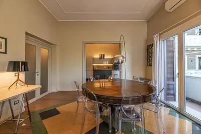 a dining room with a wooden table and chairs at Villa Ada Apartment - Parioli in Rome