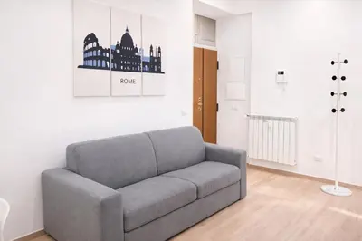 a living room with a couch and a painting on the wall at MariElu a Trastevere in Rome