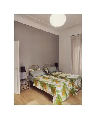 a bedroom with two beds and a lamp at Saint Bon Apartment Good for Families in Rome
