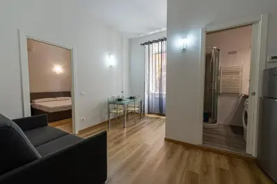 a living room with a couch and a mirror at Casa Voghera in Rome