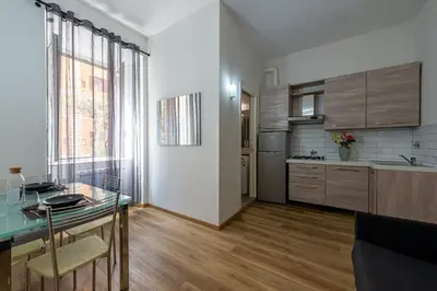 a kitchen with a glass table in a room at Casa Voghera in Rome