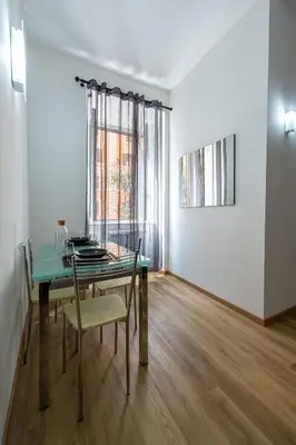 a dining room with a glass table and a window at Casa Voghera in Rome