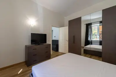 a bedroom with a bed and a television on a dresser at Casa Voghera in Rome