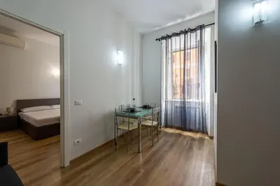 a room with a table and a bed and a mirror at Casa Voghera in Rome