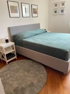 a bedroom with a bed and a rug and a table at La Dolce Vista in Rome