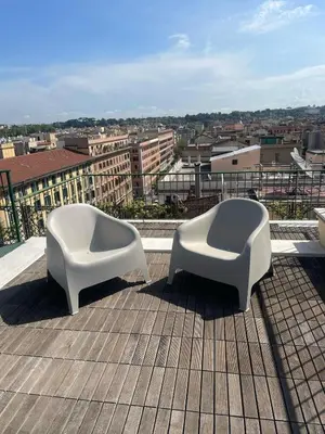 two white chairs sitting on top of a roof at La Dolce Vista in Rome