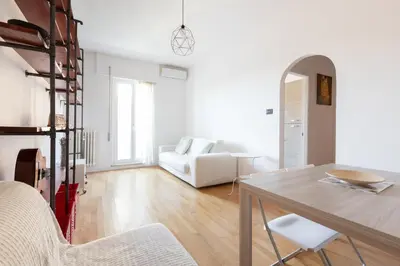 a white living room with a table and chairs at Agostini 9- Bright Flat in Rome