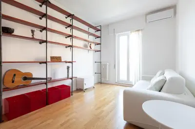 a living room with a guitar on the wall at Agostini 9- Bright Flat in Rome