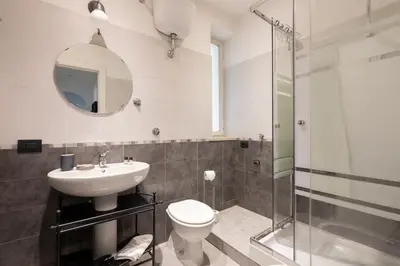 a bathroom with a toilet and a sink and a shower at Agostini 9- Bright Flat in Rome