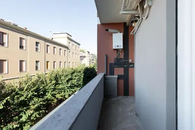 a balcony of a building with a fence and plants at Agostini 9- Bright Flat in Rome