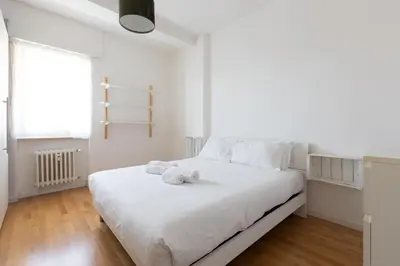 a white bedroom with a bed with towels on it at Agostini 9- Bright Flat in Rome
