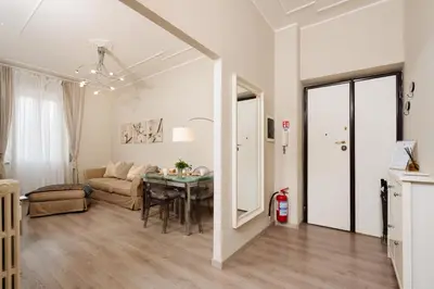 a living room with a table and a couch at Santamato Vatican Apartment in Rome
