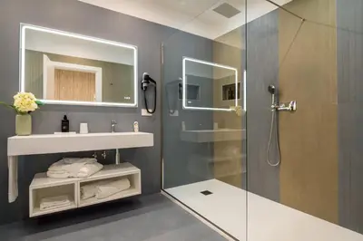 a bathroom with a shower and a sink and a mirror at 69 Suite Boutique in Rome