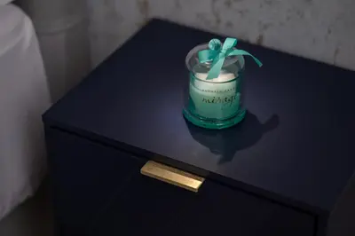 a blue table with a jar with a green bow at 69 Suite Boutique in Rome