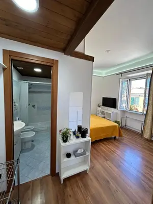 a bedroom with a bed and a bathroom with a sink at Villa Lanusei in Rome