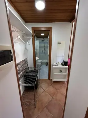a bathroom with a sink and a toilet and a mirror at Villa Lanusei in Rome