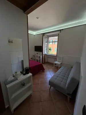 a living room with a couch and a bed at Villa Lanusei in Rome