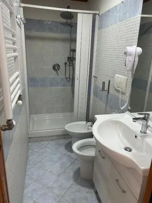 a bathroom with a toilet and a sink and a shower at Villa Lanusei in Rome