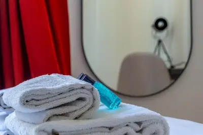 a stack of towels and a toothbrush on a table at iFlat Monti Brand New Spacious & Comfortable Gem in Rome
