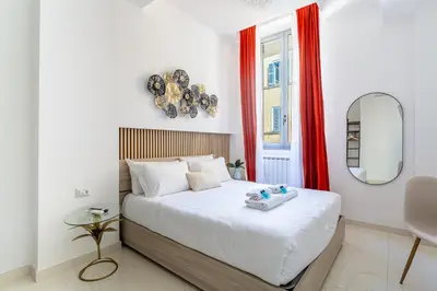 a bedroom with a large bed and a mirror at iFlat Monti Brand New Spacious & Comfortable Gem in Rome