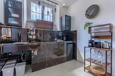 a kitchen with a counter with a clock on the wall at iFlat Monti Brand New Spacious & Comfortable Gem in Rome
