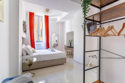 a bedroom with a bed and a desk at iFlat Monti Brand New Spacious & Comfortable Gem in Rome