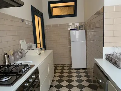 a kitchen with a stove and a white refrigerator at Santa Monica in Rome