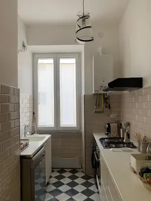 a white kitchen with a sink and a stove at Santa Monica in Rome