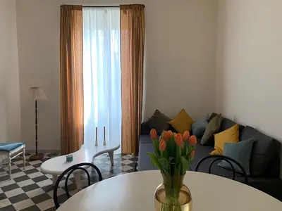 a living room with a couch and a table with flowers at Santa Monica in Rome