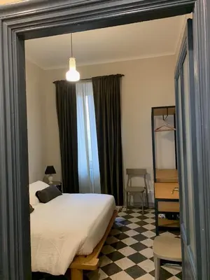 a bedroom with a bed and a desk and a window at Santa Monica in Rome