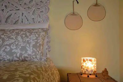 a bedroom with a bed and a lamp on a table at Trastevere elegant apartment in Rome
