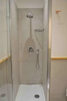 a shower with a glass door in a bathroom at Trastevere elegant apartment in Rome