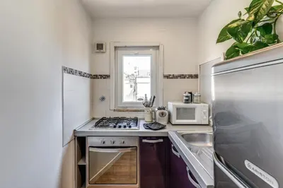 a small kitchen with a stove and a microwave at Attic with terrace Spanish Steps exclusive in Rome
