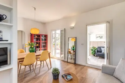 a living room with a table and chairs at Attic with terrace Spanish Steps exclusive in Rome