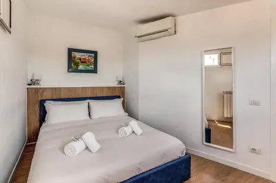 a bedroom with a large bed with two pillows at Attic with terrace Spanish Steps exclusive in Rome