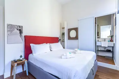 a bedroom with a large bed with a red headboard at iFlat Contemporary Design Living in Rome in Rome