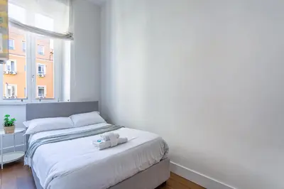a bedroom with a bed with two towels on it at iFlat Contemporary Design Living in Rome in Rome