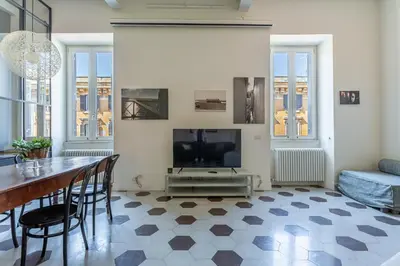a living room with a dining table and a television at iFlat Contemporary Design Living in Rome in Rome