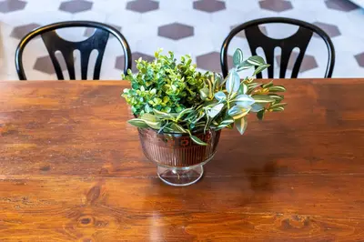 a vase of flowers sitting on a wooden table at iFlat Contemporary Design Living in Rome in Rome