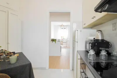 a kitchen with a stove and a refrigerator at Caracciolo Vatican Apartment in Rome