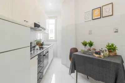 a kitchen with a table with a table cloth on it at Caracciolo Vatican Apartment in Rome